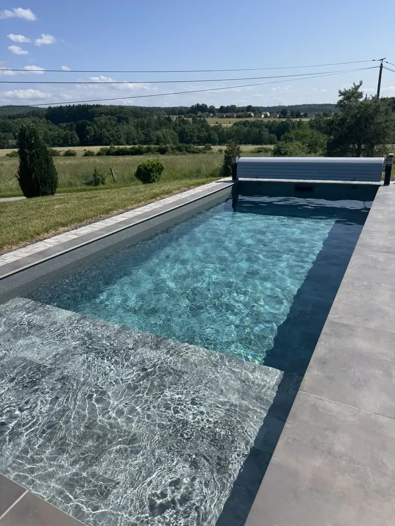 Piscine équipée d'un volet immergé, ouverte sur une vallée vosgienne