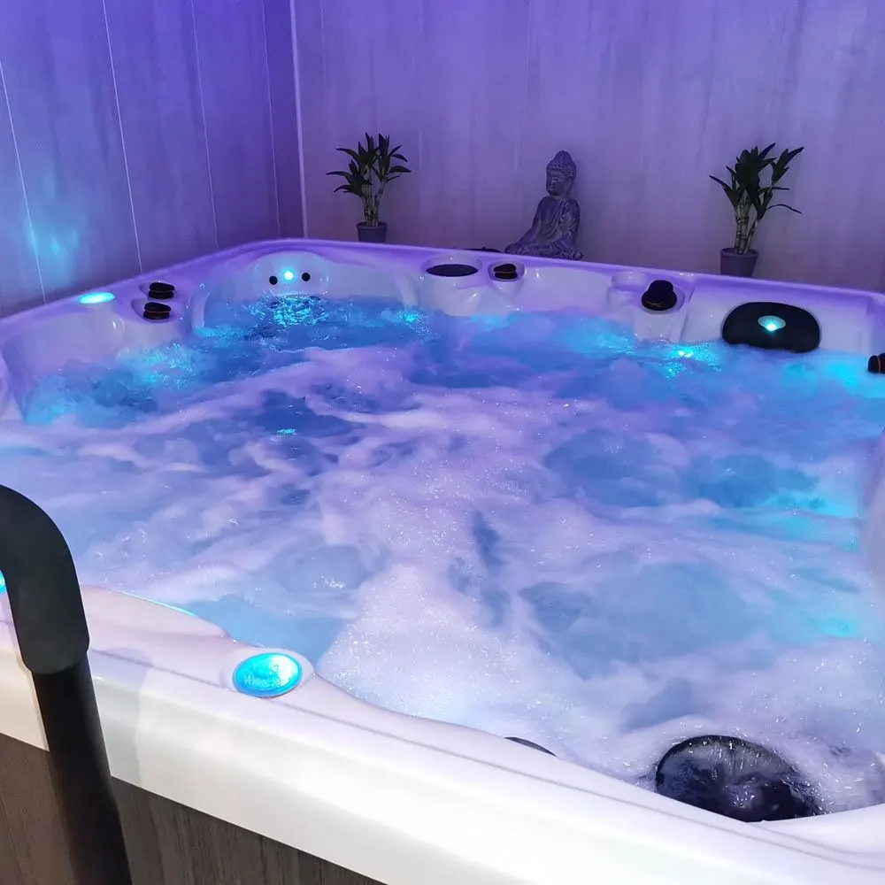 Spa extérieur en fonctionnement de nuit avec éclairage chromothérapie violet